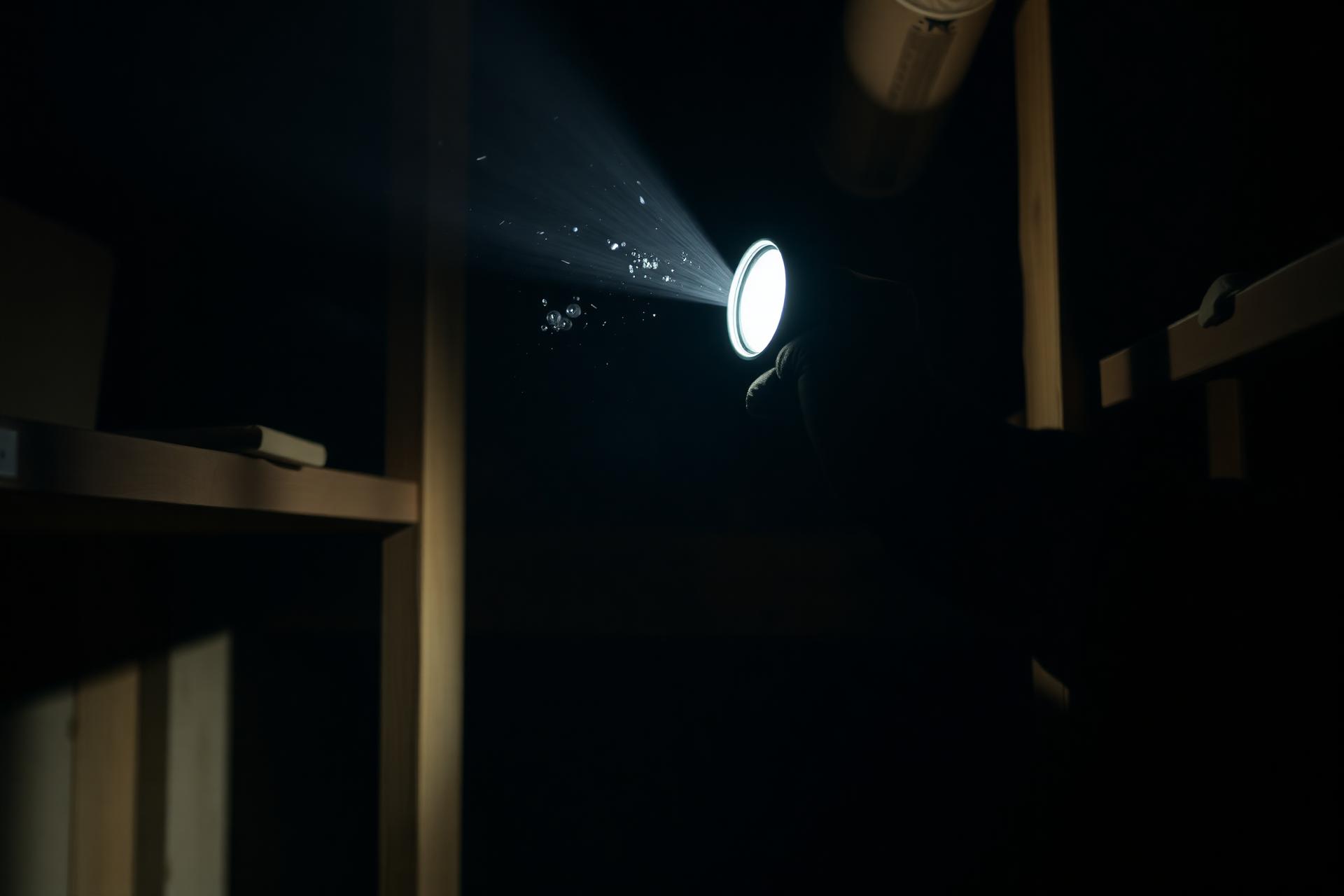 Inspecting a dim storage area with a flashlight